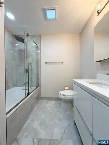 a bathroom with a toilet sink and shower