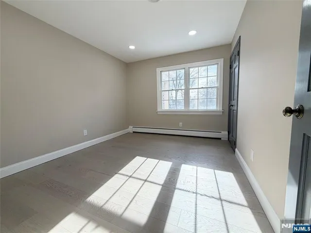 a view of an empty room and a window