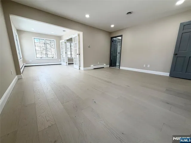 an empty room with windows and closet