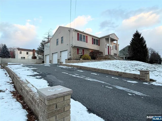 a front view of a house with a road