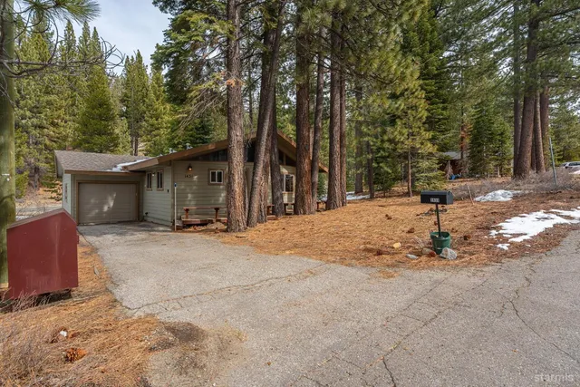 a view of a house with trees in the background