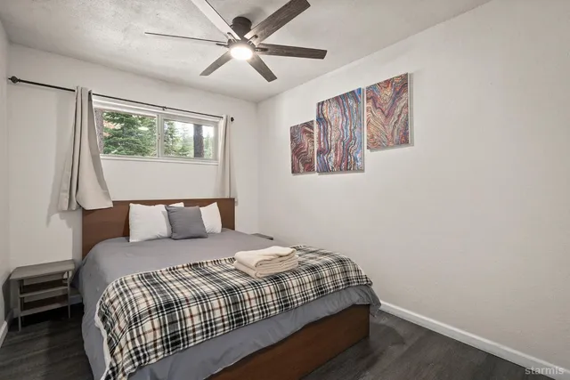 a bedroom with a large bed and a window