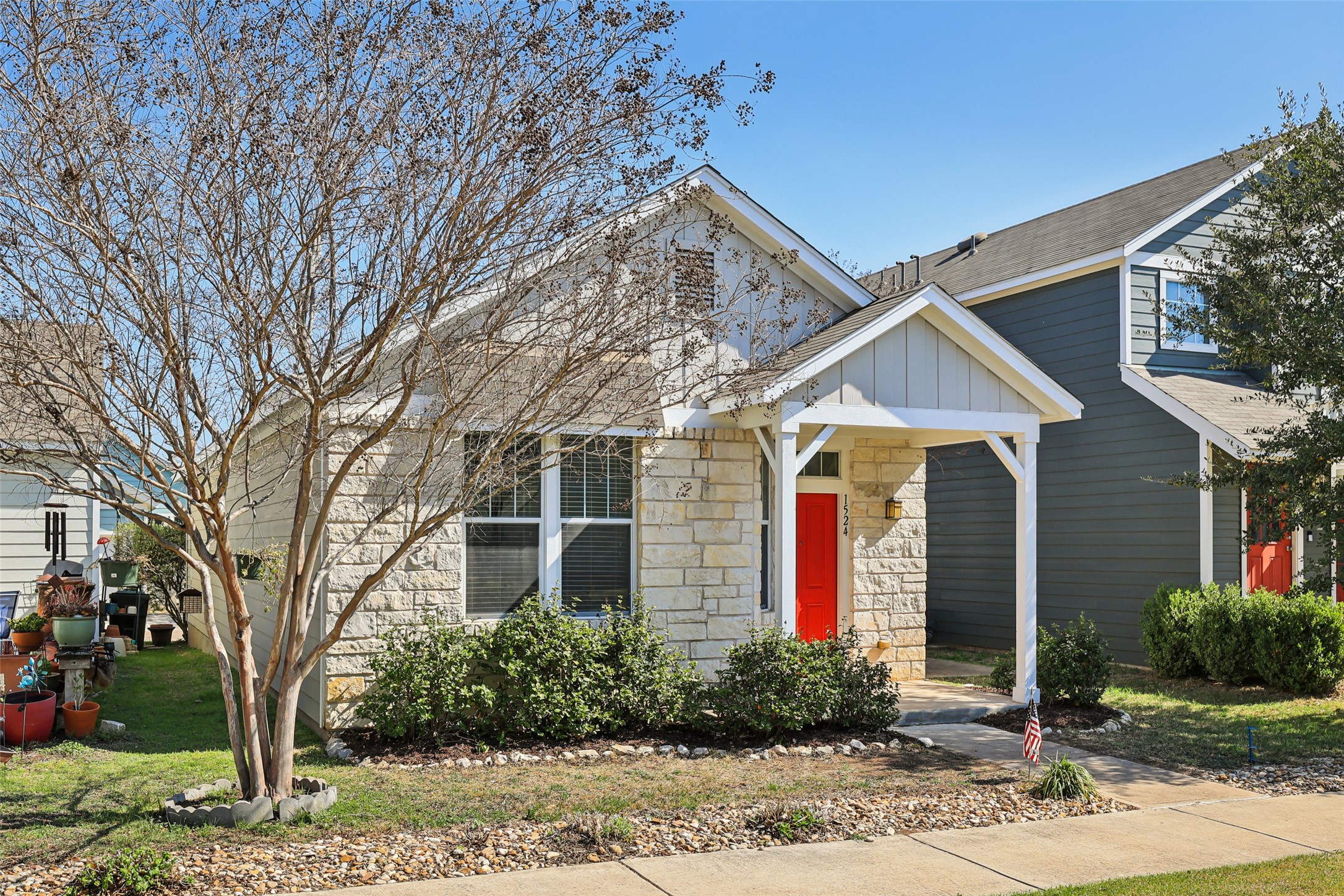 1524 Sanders Kyle, TX 78640 - Photo 33 of 37 View of front of home with stone siding and a front lawn