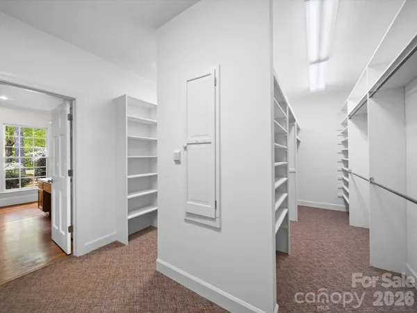 a view of walk in closet with empty racks