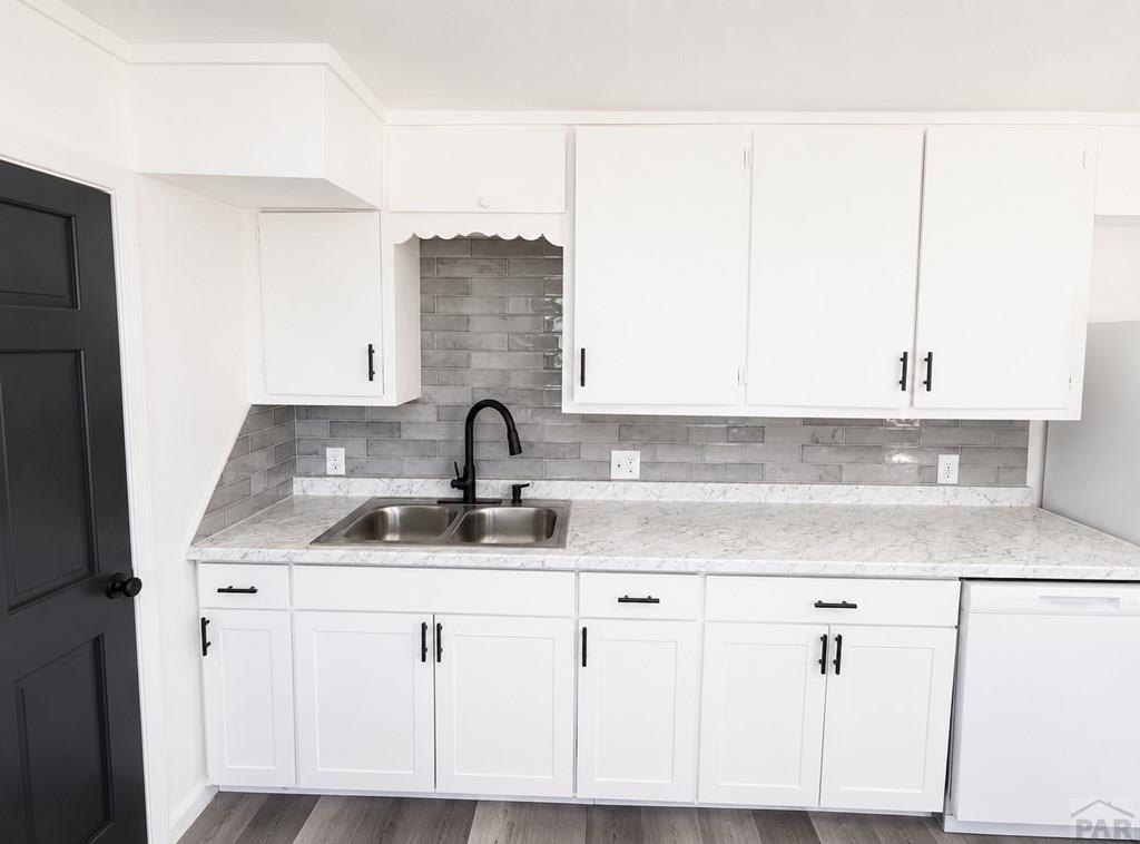 207 Spring Street Pueblo, CO 81003 - Photo 9 of 11 a kitchen with cabinets and white appliances