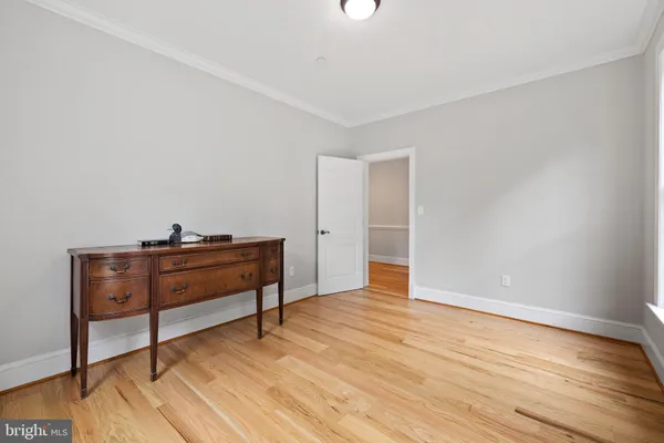 a view of room with wooden floor and furniture