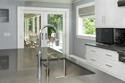 a kitchen with a white cabinets and outdoor space