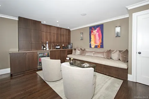 a living room with furniture a wooden floor and a large window