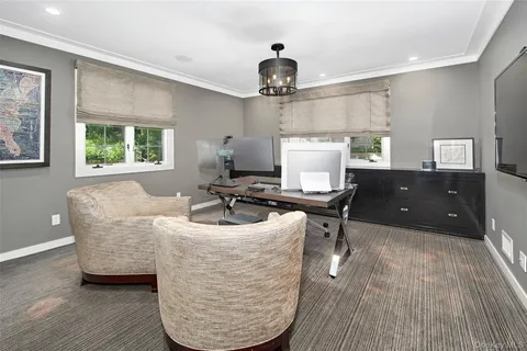 a living room with a table chairs and a wooden floor