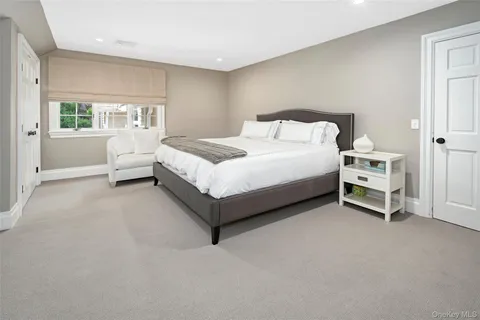 a spacious bedroom with a bed and a large window