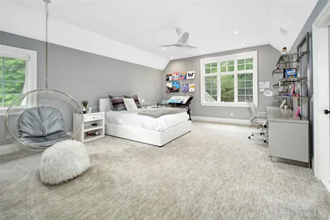 a spacious bedroom with a bed and a large window