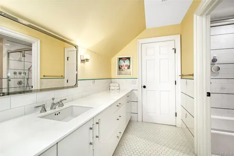 a spacious bathroom with a double vanity sink mirror and