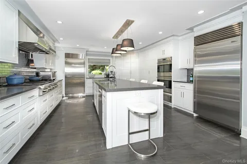 a kitchen with a sink stainless steel appliances and cabinets