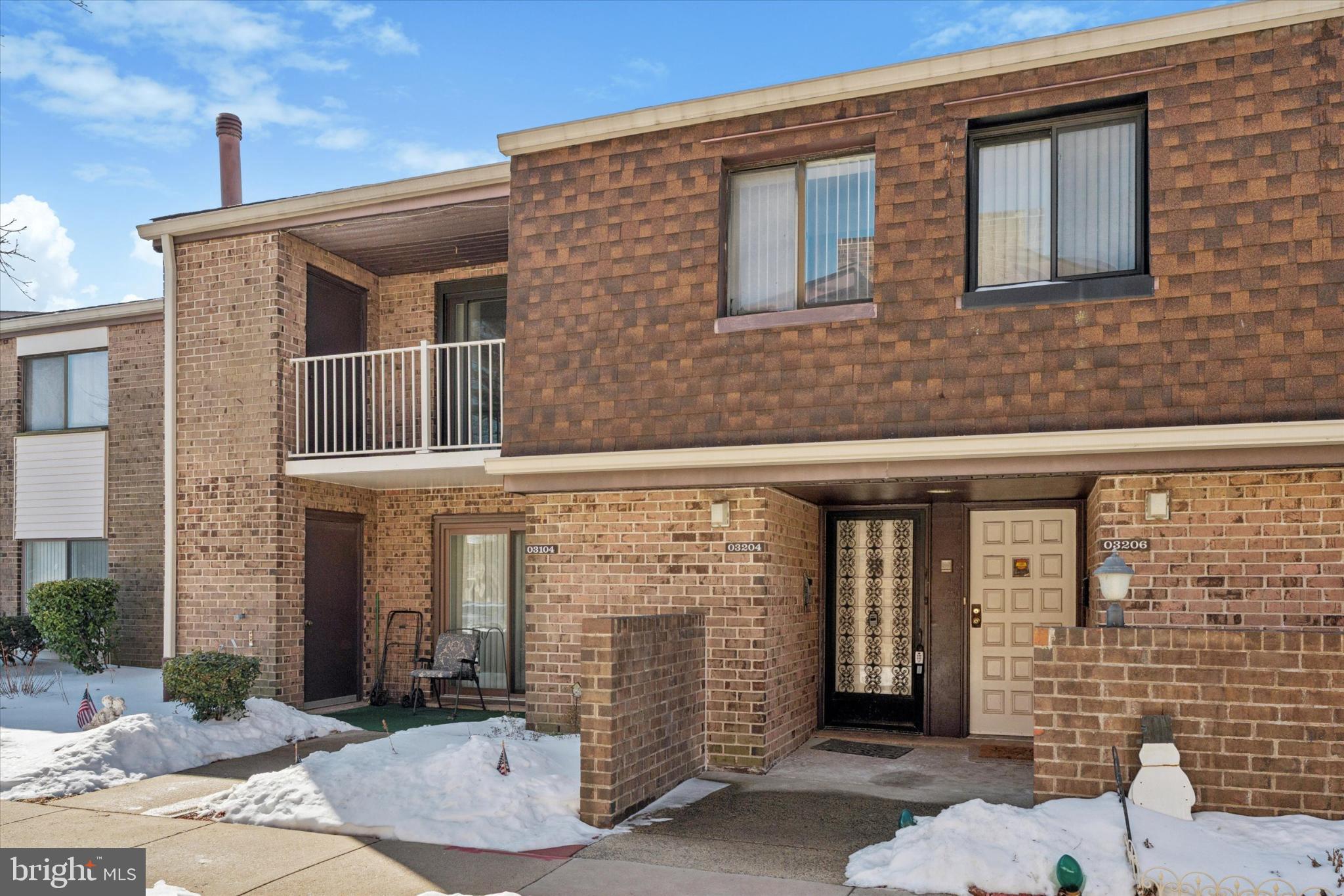Charming brick facade with winter's touch.