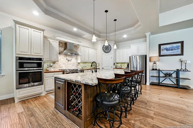 a view of a dining room with furniture kitchen and chandelier