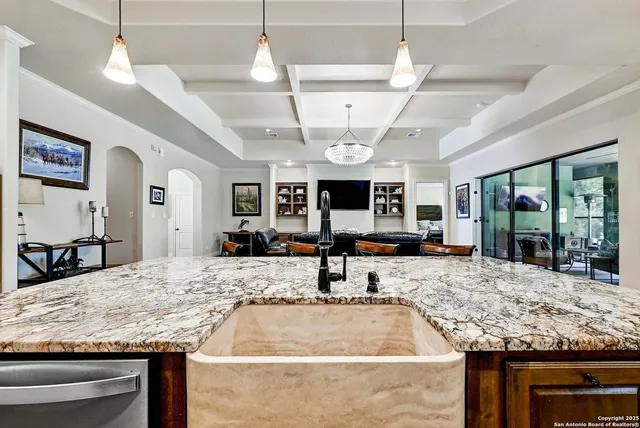a view of a living room and kitchen center island