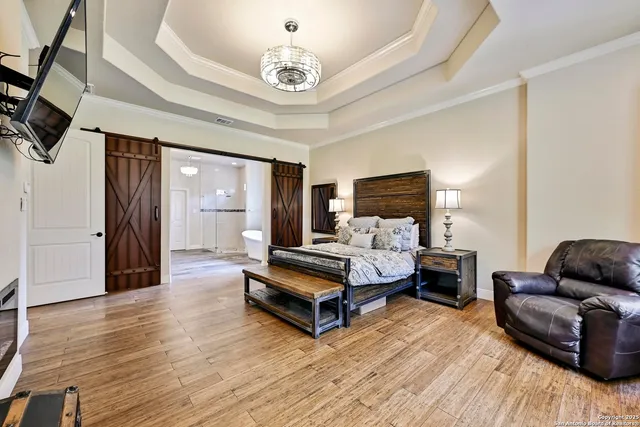 a bedroom with furniture and wooden floor