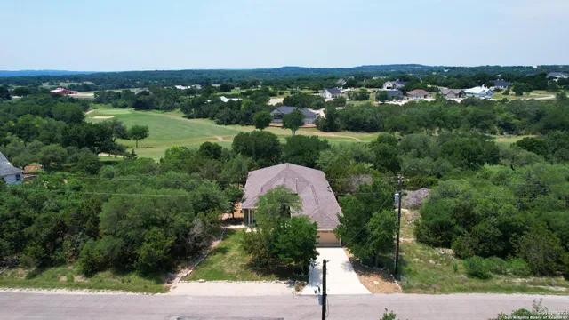 an aerial view of a house with a yard