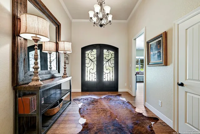 a view of a hallway with entryway windows and chandelier