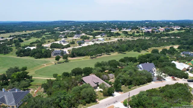an aerial view of residential houses with city view