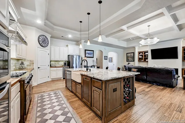 a kitchen with stainless steel appliances granite countertop a stove and a large kitchen island