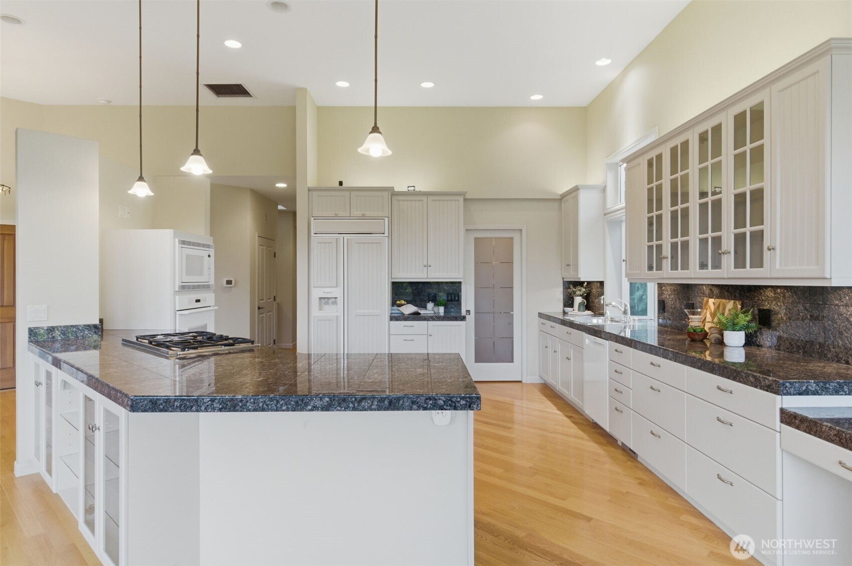 2263 Lost Mountain Road Sequim, WA 98382 - Photo 10 of 40 a large kitchen with kitchen island a large center island a sink stainless steel appliances and cabinets