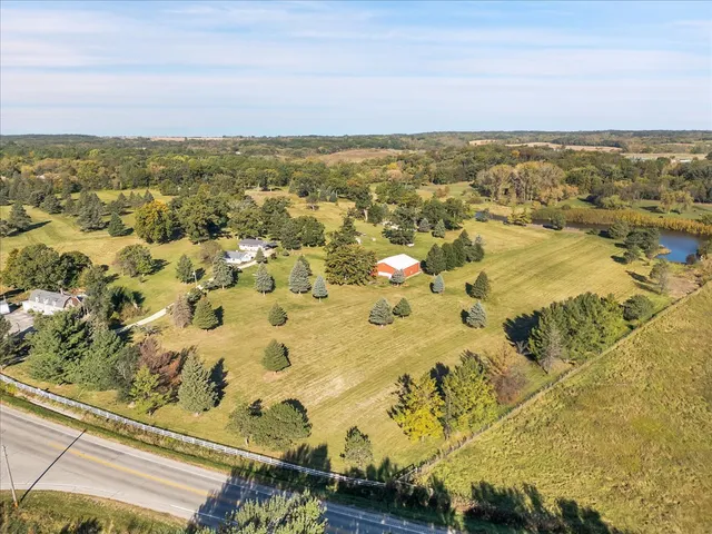 a aerial view of a house with a yard and lake view