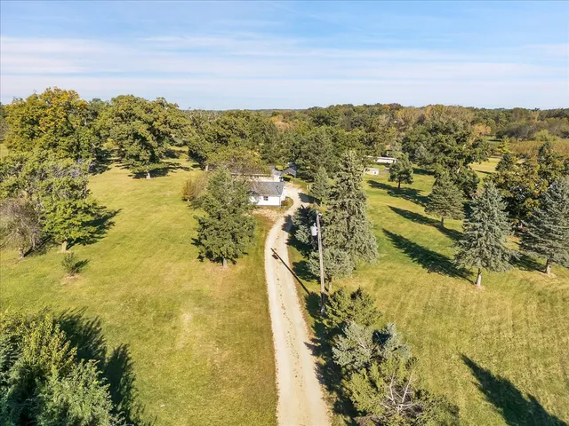 a view of a ocean with boats and trees in the background