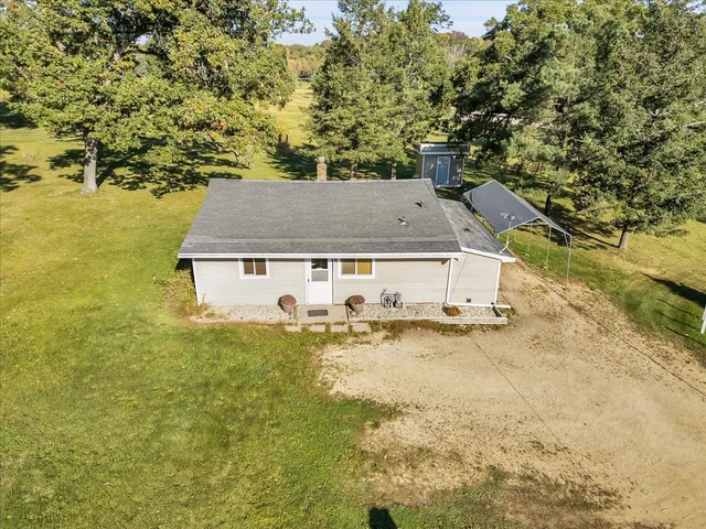 an aerial view of a house with yard