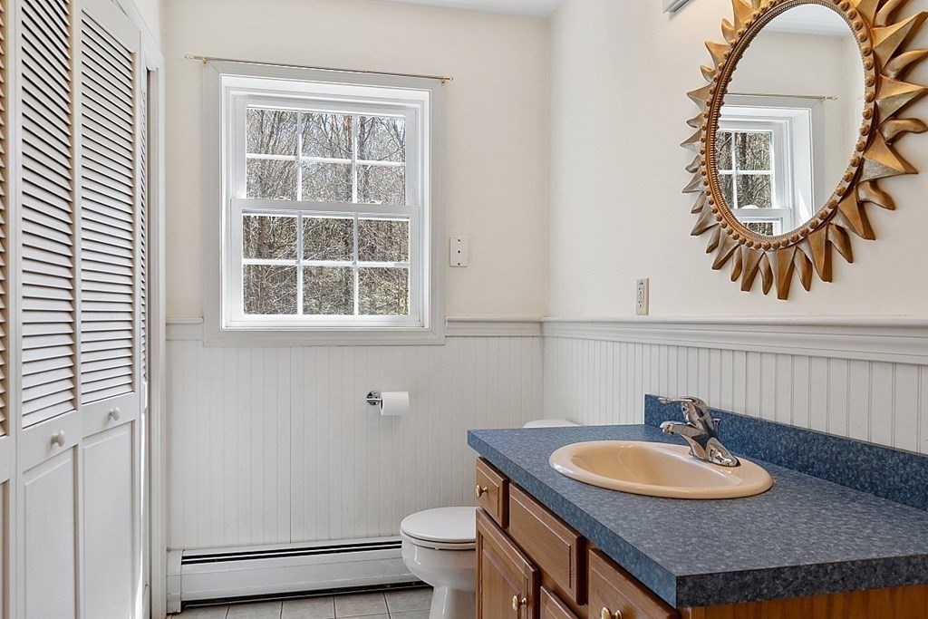 214 Hastings Road Ashburnham, MA 01430 - Photo 13 of 39 a bathroom with a granite countertop sink and a mirror