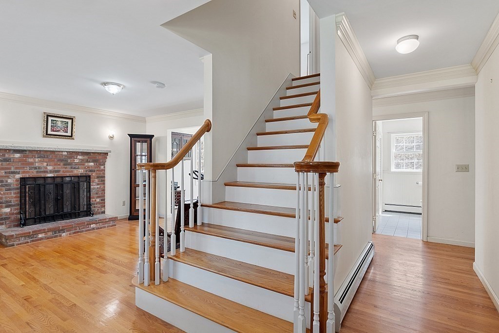 214 Hastings Road Ashburnham, MA 01430 - Photo 19 of 39 a view of a hallway with wooden floor and fireplace