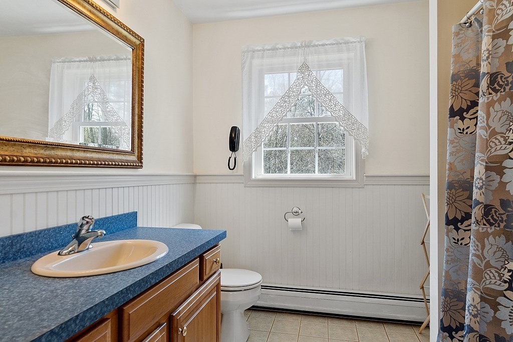 214 Hastings Road Ashburnham, MA 01430 - Photo 23 of 39 a bathroom with a sink a toilet and a mirror