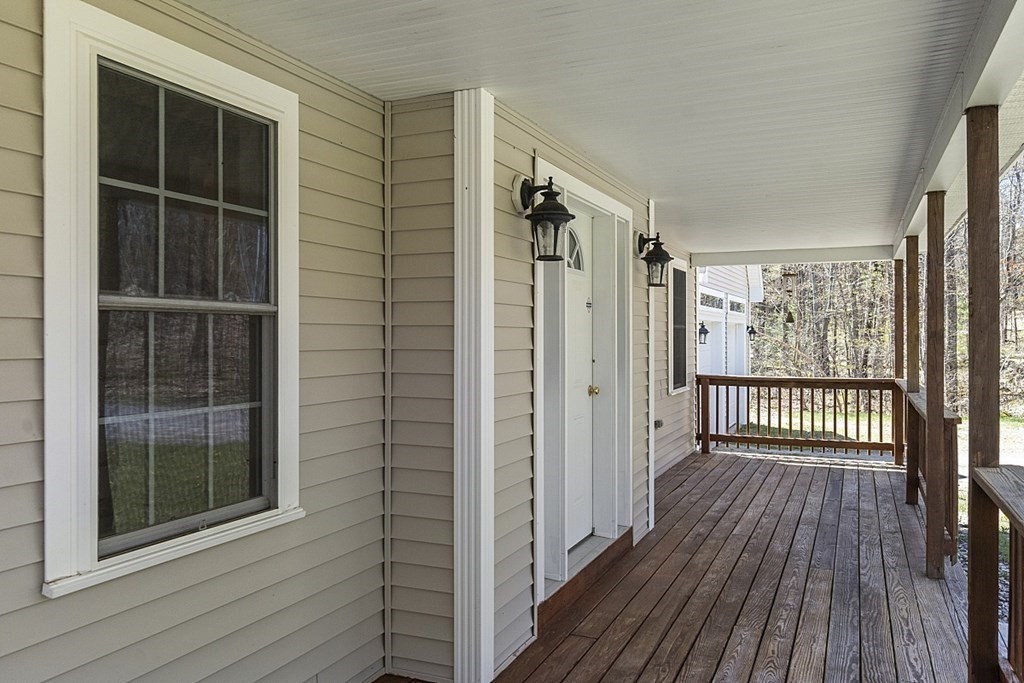 214 Hastings Road Ashburnham, MA 01430 - Photo 4 of 39 a view of a balcony with wooden floor and door