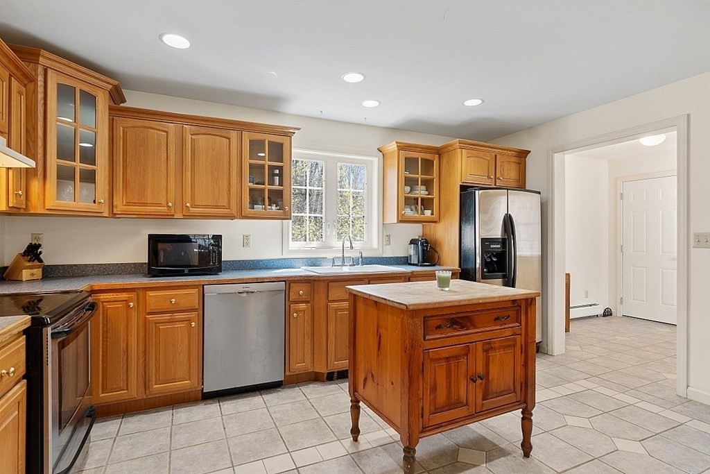 214 Hastings Road Ashburnham, MA 01430 - Photo 10 of 39 a kitchen with stainless steel appliances granite countertop a sink and a refrigerator