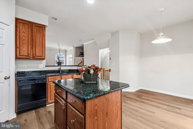 a kitchen with granite countertop a stove and a sink