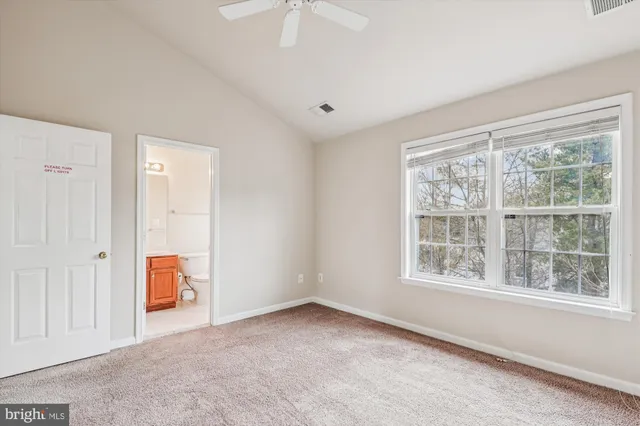 an empty room with windows and cabinet
