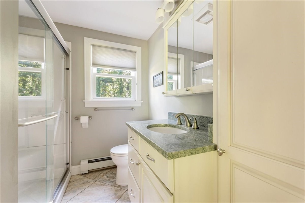 152 Alley Road Rochester, MA 02770 - Photo 13 of 26 a bathroom with a granite countertop sink a toilet and a window