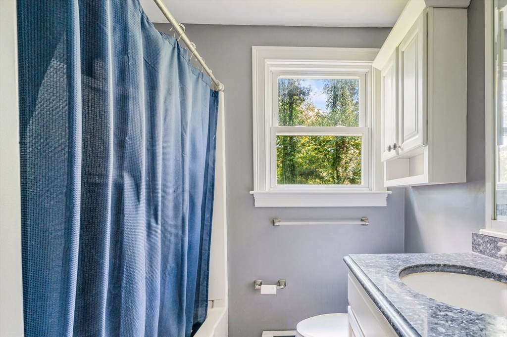 152 Alley Road Rochester, MA 02770 - Photo 19 of 26 a bathroom with a granite countertop sink toilet and window