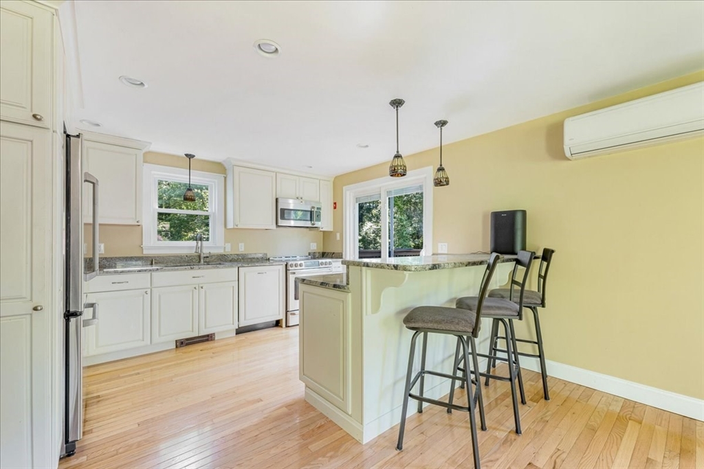 152 Alley Road Rochester, MA 02770 - Photo 5 of 26 a kitchen with a table chairs refrigerator and cabinets
