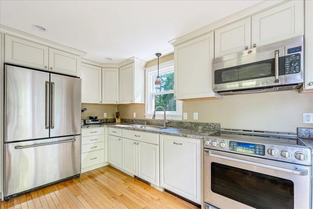 152 Alley Road Rochester, MA 02770 - Photo 8 of 26 a kitchen with stainless steel appliances white cabinets white stove a sink and a refrigerator