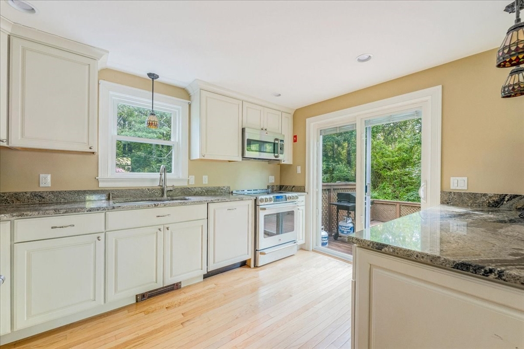 152 Alley Road Rochester, MA 02770 - Photo 9 of 26 a kitchen with granite countertop white cabinets and a large window