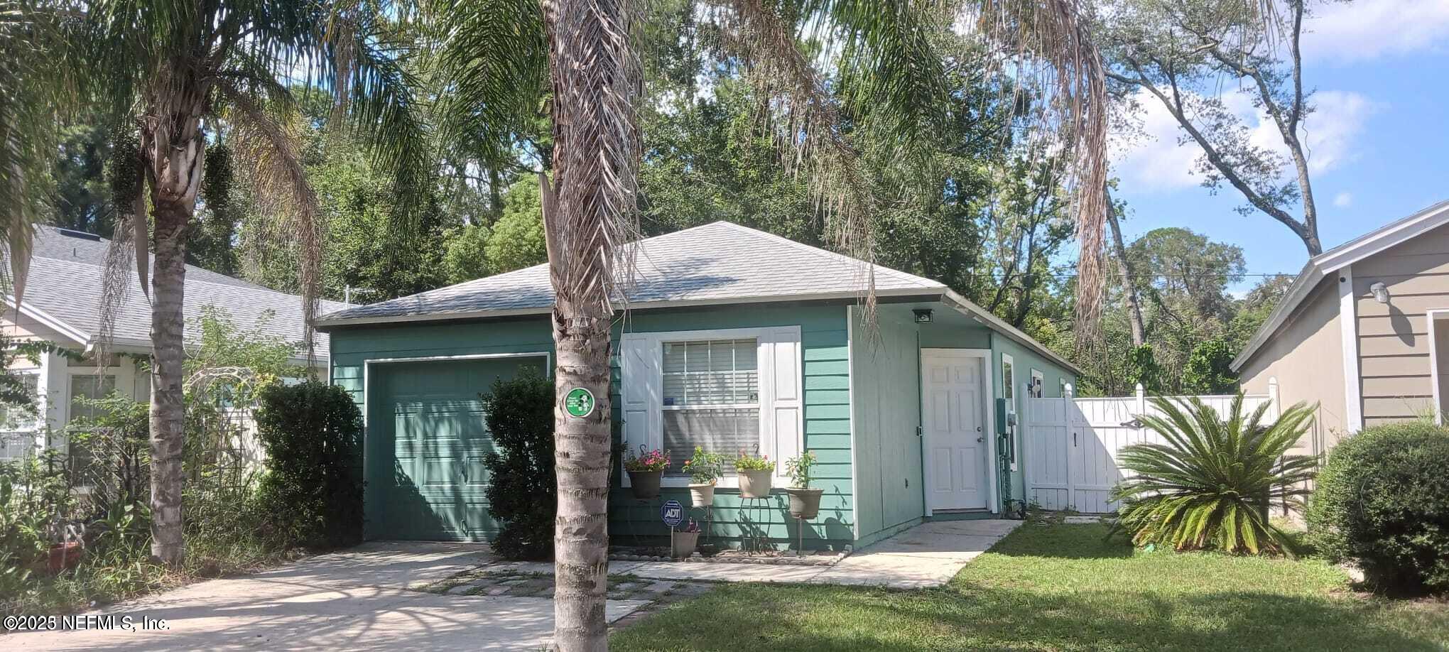 5653 Ellis Trace Drive Jacksonville, FL 32205 - Photo 1 of 12 a front view of a house with garden