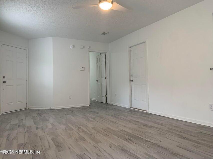 5653 Ellis Trace Drive Jacksonville, FL 32205 - Photo 3 of 12 an empty room with wooden floor and windows