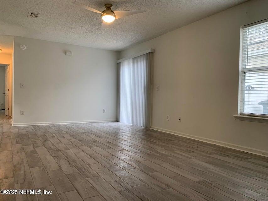 5653 Ellis Trace Drive Jacksonville, FL 32205 - Photo 4 of 12 a view of an empty room with wooden floor and a window