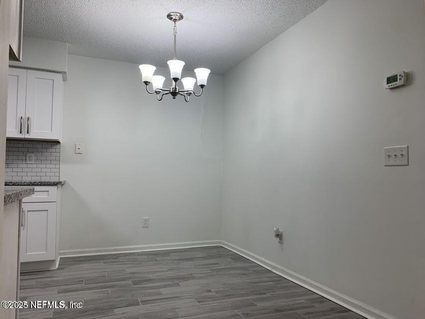 5653 Ellis Trace Drive Jacksonville, FL 32205 - Photo 6 of 12 a view of a chandelier fan and hardwood floor