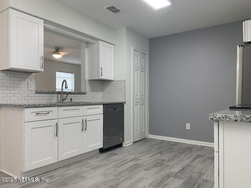 5653 Ellis Trace Drive Jacksonville, FL 32205 - Photo 7 of 12 a kitchen with granite countertop white cabinets and a sink