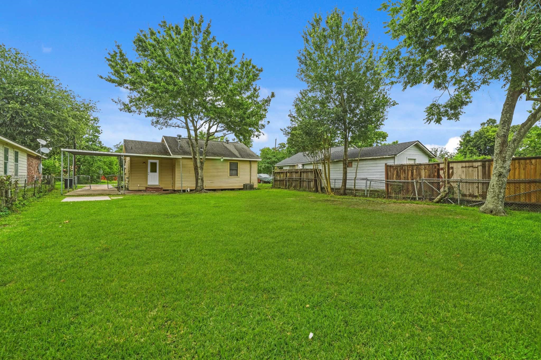 1718 Miami Road Pasadena, TX 77502 - Photo 10 of 11 a view of a house that has a small yard and a large tree