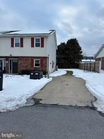 a view of a house with a yard covered in snow