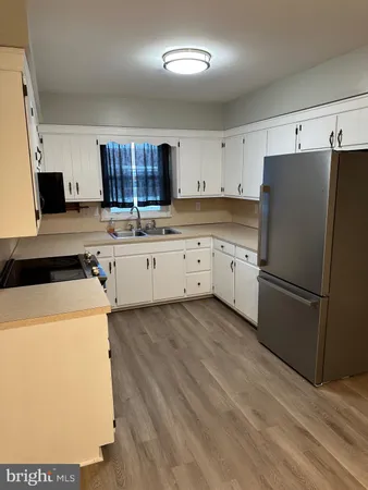 a kitchen with a refrigerator sink and stove
