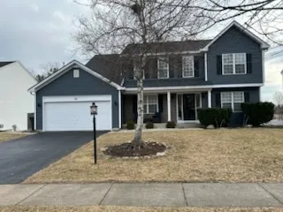 a front view of a house with a garden and yard